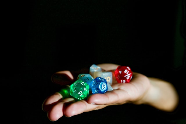 A hand outstreached with a set of rpg dice in them